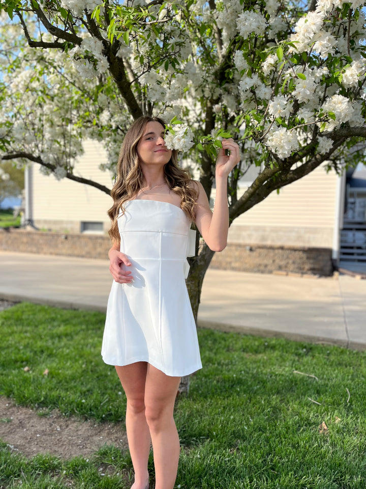 White strapless mini dress with large bow on back