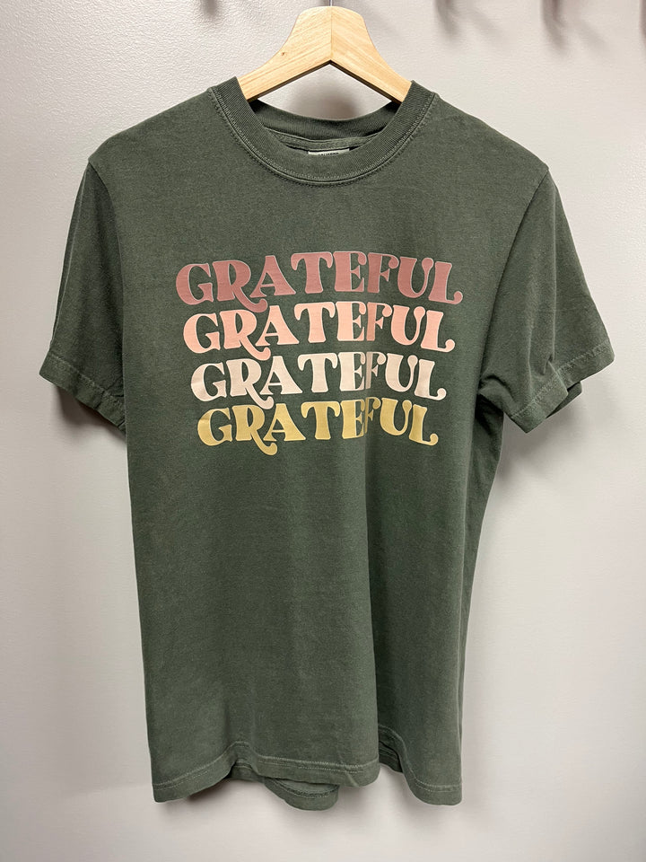 Moss green tshirt with the word ‘GRATEFUL’ repeated on the front