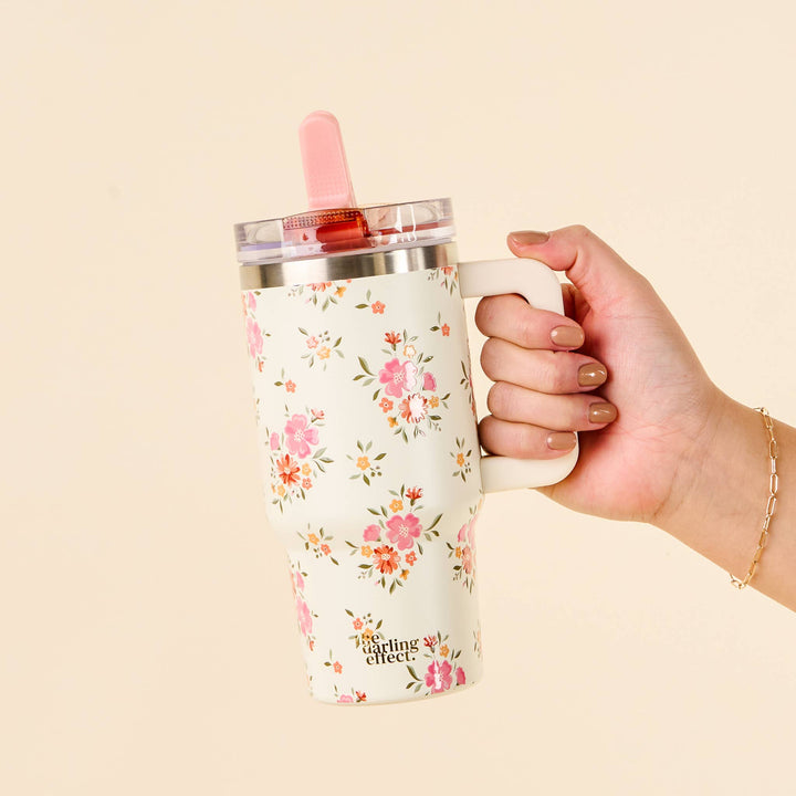 floral-patterned tumbler with a pink straw, cream colored tumbler 20 oz