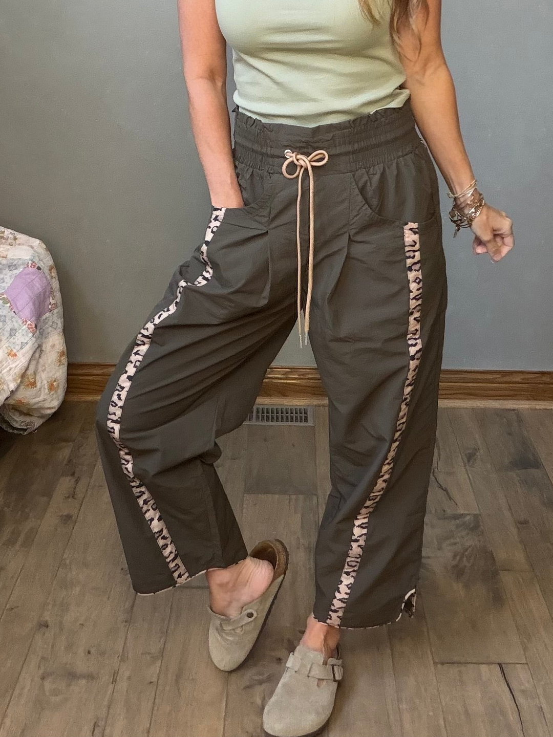 Olive windbreaker pants with cheetah stripes