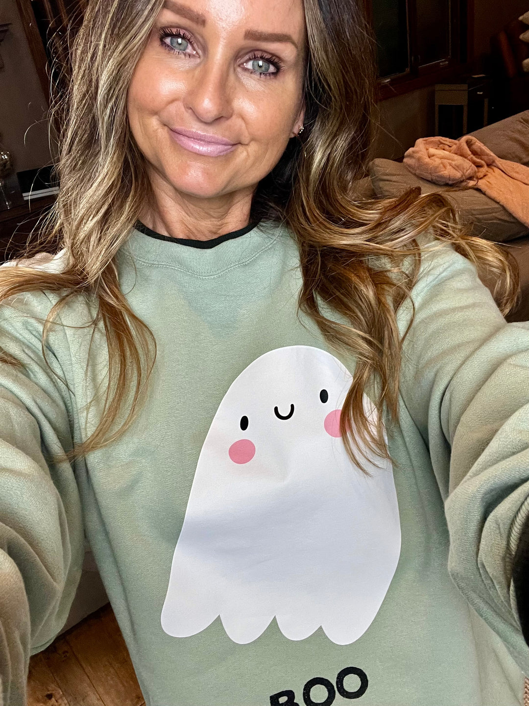 Sage green sweatshirt with white ghost says BOO