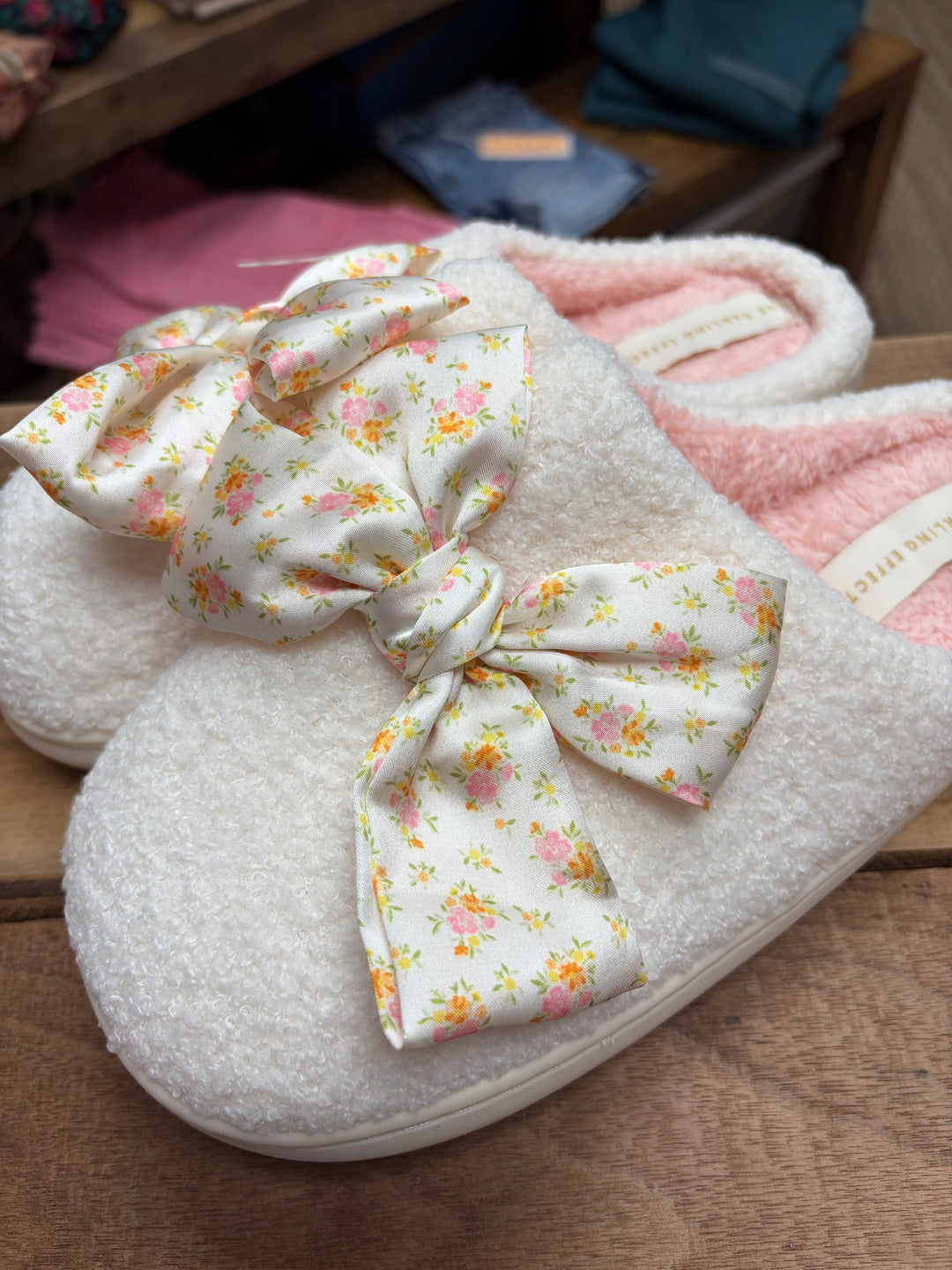 White fuzzy slippers with floral satin bow