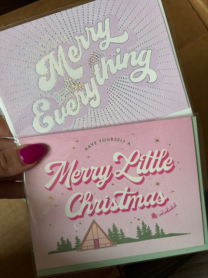 Christmas greeting cards with decorative text and designs.