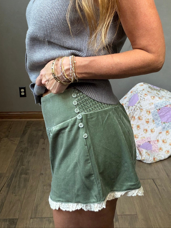 Green velvet shorts with lace trim