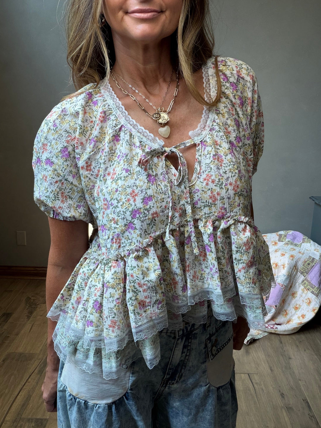 short-sleeve floral lace blouse with a ruffled peplum hem and tie-front detail