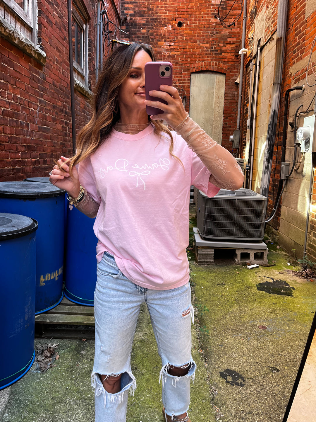 Light pink tee with Game Day in a white feminine font with a dainty bow