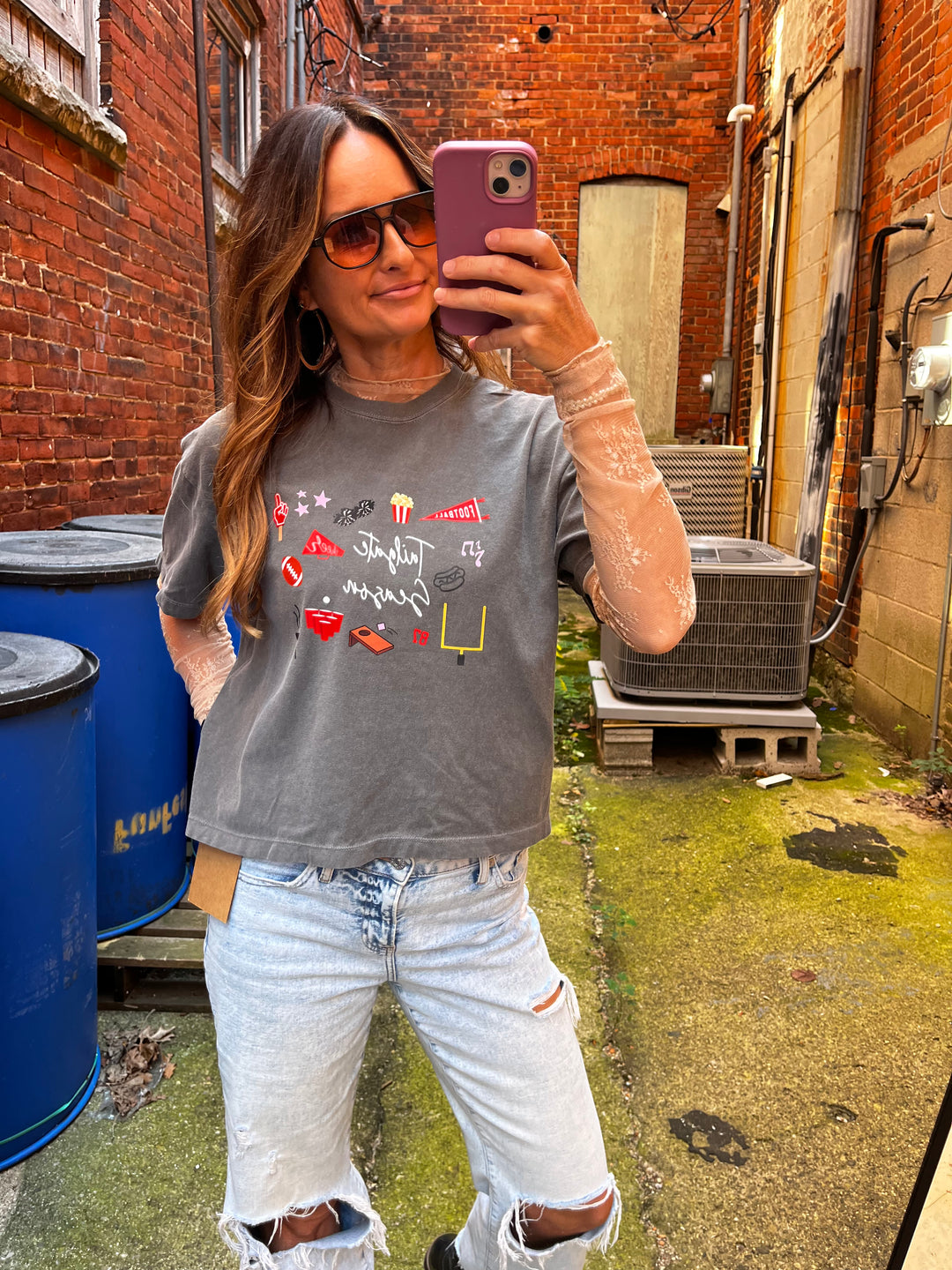 Charcoal gray cropped tee that says Tailgate Season with football doodle graphics 