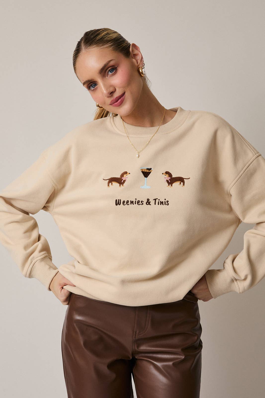 Tan fleece sweatshirt with 'Weenies & Tinis' text and dachshund illustrations